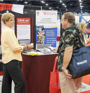 A convention delegate visits with a representative of the LCMS Church Information Center in the exhibit hall at the 2010 Synod Convention in Houston.