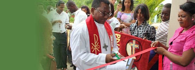 Pastor Willy Gaspar of the Evangelical Lutheran Church in the Dominican Republic cuts the ribbon for a new church.