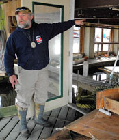 Rick Pullen shows how high flood waters rose in his home.