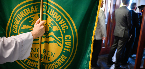 Hand holding pole of green banner at the Opening Service for the 183rd academic year with the installation of the Rev. Dr. Thomas J. Egger at Concordia Seminary, St. Louis.