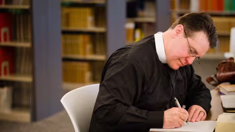 A pastor studying