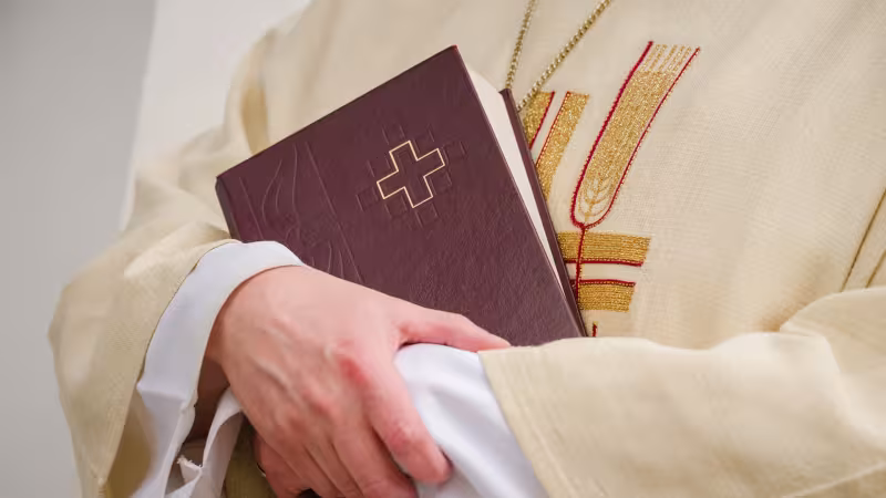 Pastor holding hymnal