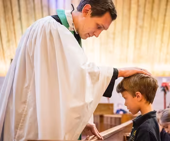 Pastor blessing a child